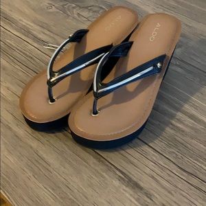 Aldo black platform flip flops size 6.